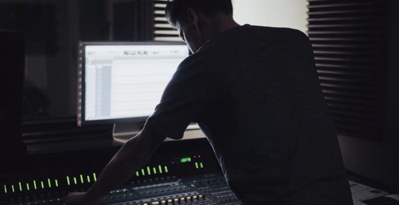 Guy on mixing desk doing a pro tools first tutorial
