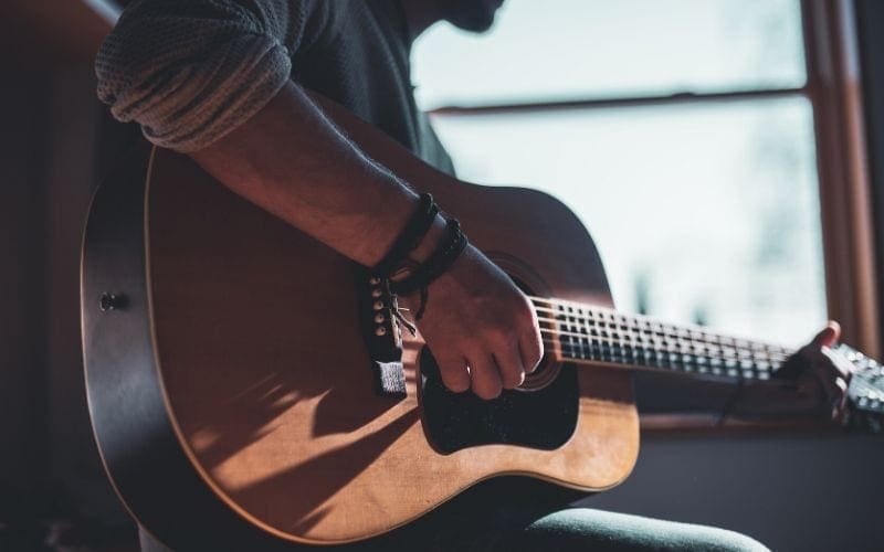 Man playing guitar Chords music theory