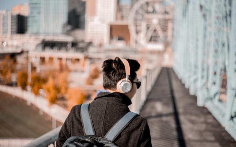 Man listening to music on headphones Мusic Gateway