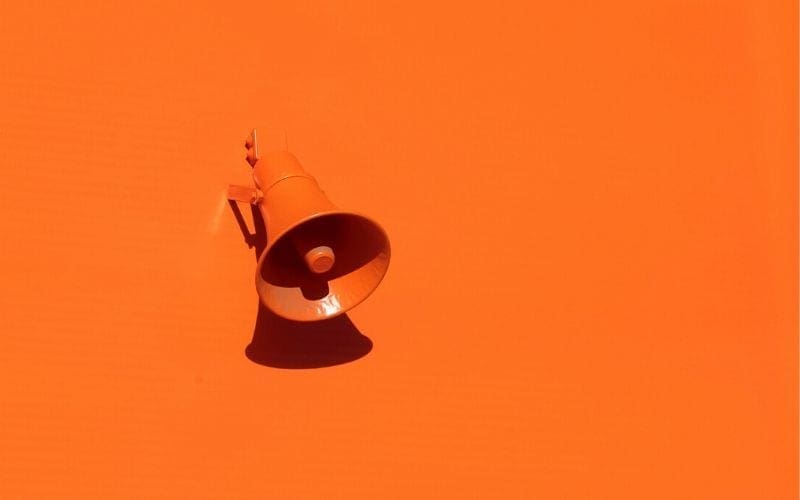 Orange wall with orange speaker or megaphone
