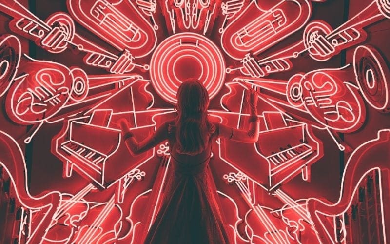 Woman standing by neon signs