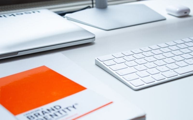 White desk with book on 'Brand Identity' how to build a brand