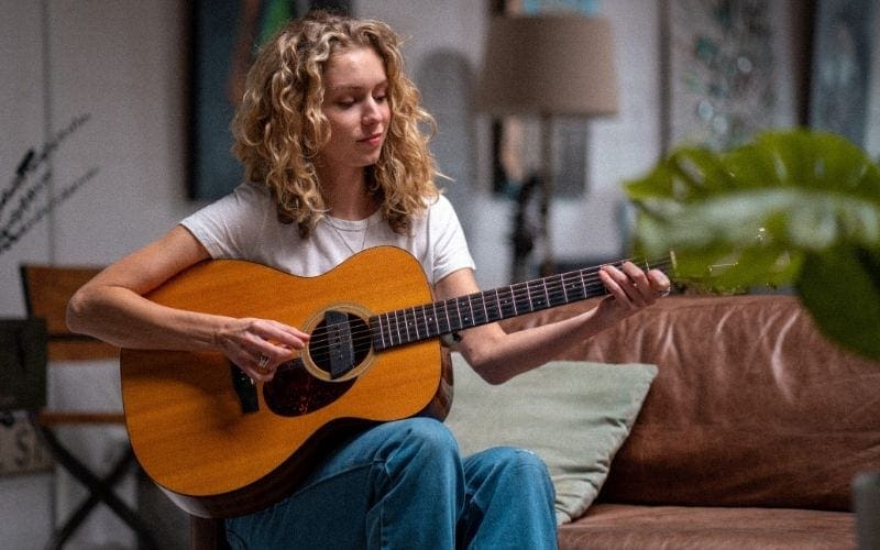 Woman playing guitar - recording music