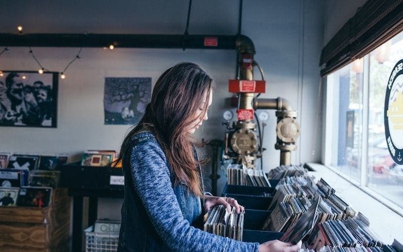 woman browsing through records music supervisor