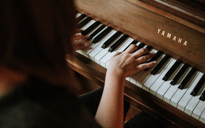 woman playing piano chords