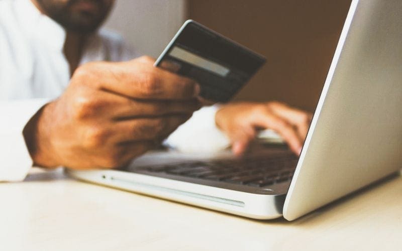 man with laptop and credit card