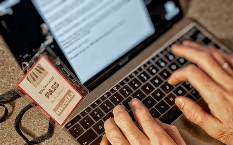 man typing on laptop