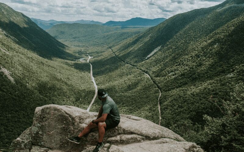 A man on a rock location scouting.