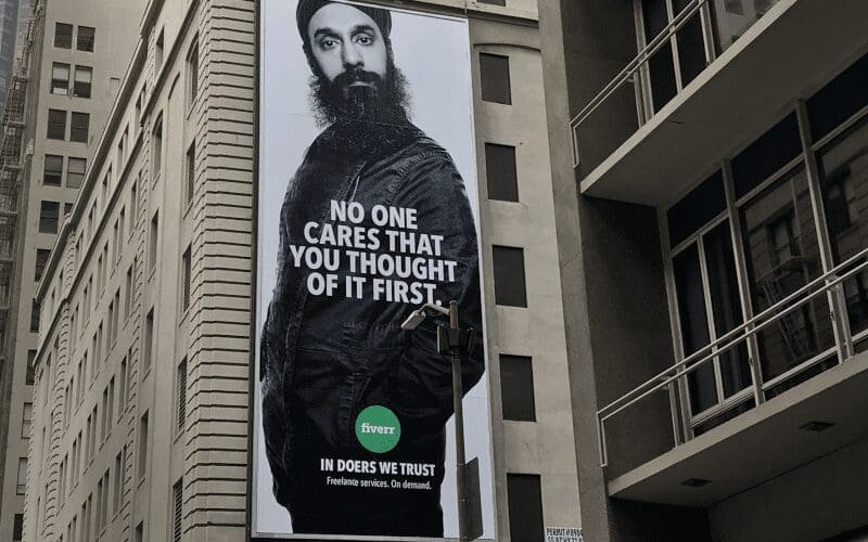 A long billboard advertising Fiverr.
fiverr.com.