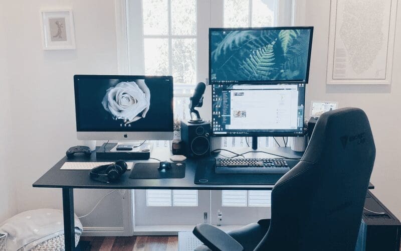 A Gaming chair infront of a desktop set up.