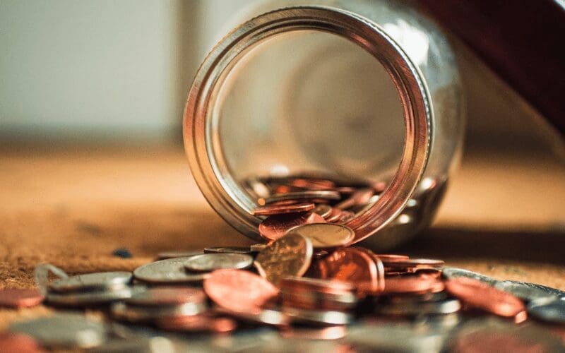 A spilled jar containing pennies.