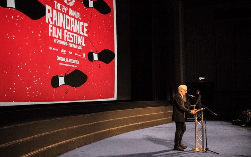 Elliot Grove giving a speech at a Raindance film festival.