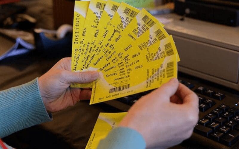 hands holding sundance film festival tickets