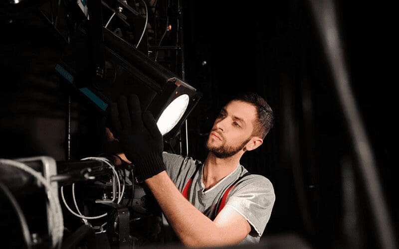 Set designer helping with equipment