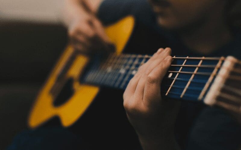 man learning guitar