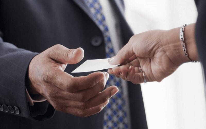 exchnanging business cards at networking event