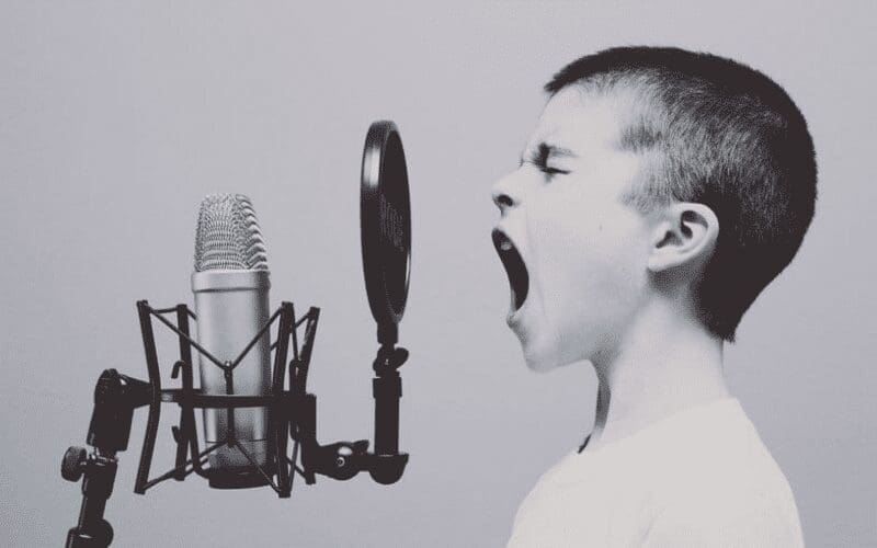 child singing into microphone