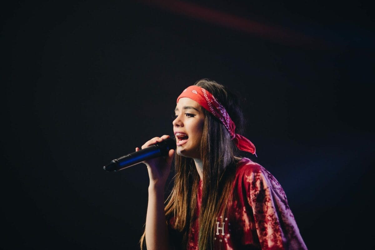 Woman singing on stage singing live