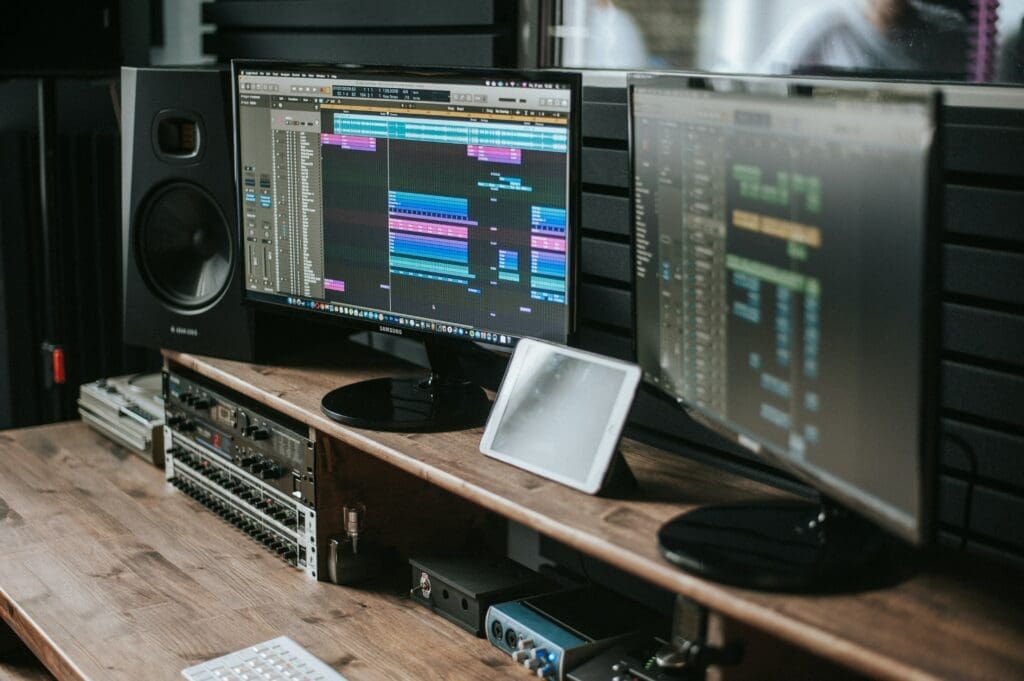 Two monitors showing Ableton music production software